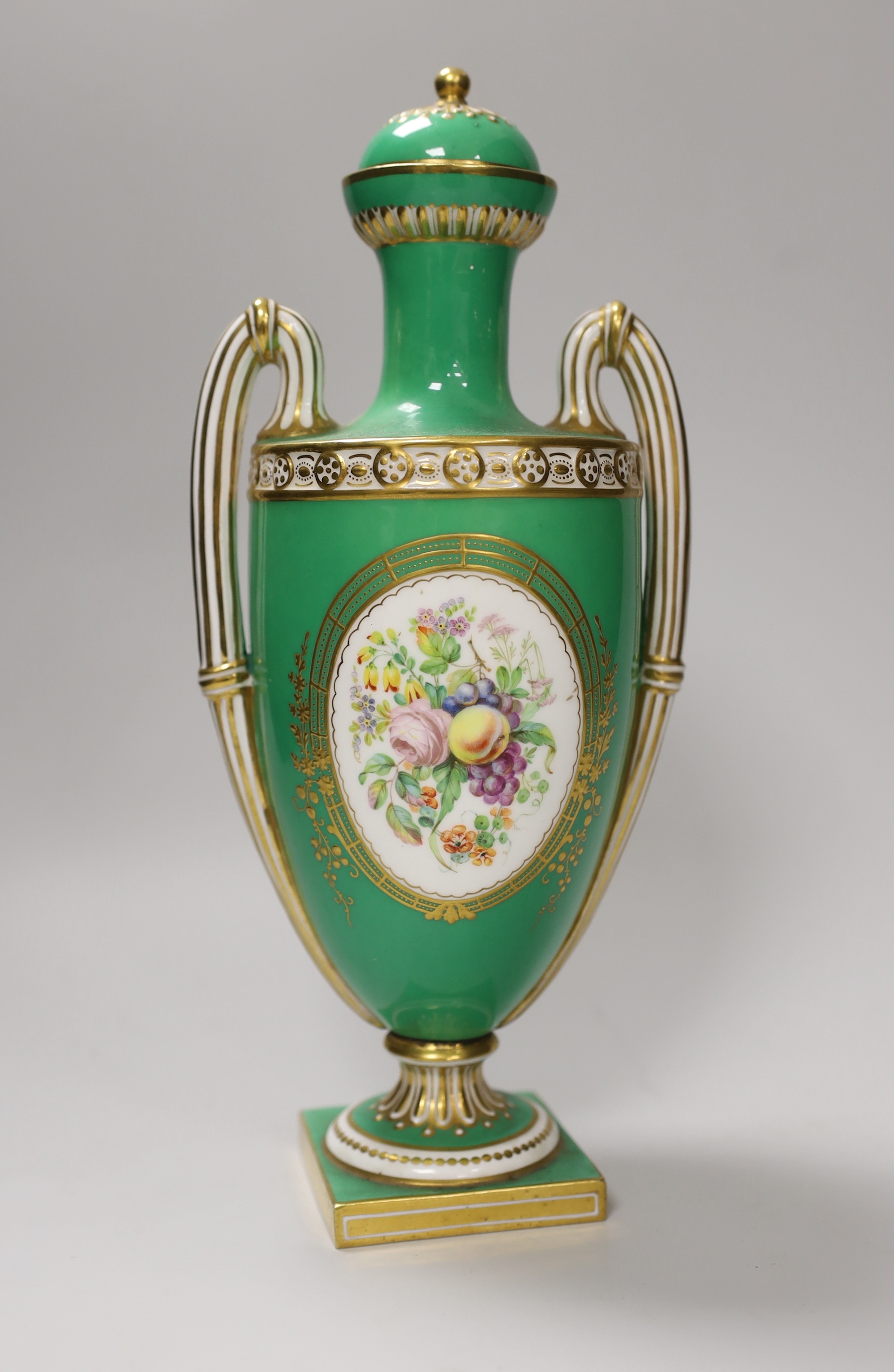 A Coalport two handled green ground vase and cover painted with a landscape, verso with fruit by Cook, 28cm high